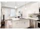 Open-concept living space with a bright kitchen featuring stainless appliances and island at 2110 Decatur St, Denver, CO 80211