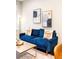 Comfortable living room featuring a cozy blue sofa and stylish decor at 2110 Decatur St, Denver, CO 80211