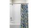 Shower features white subway tile and stylish printed curtain at 2110 Decatur St, Denver, CO 80211