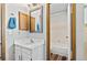 Bright bathroom features a sink, cabinet, a framed mirror, and a shower with updated fixtures at 10715 Foxwood Ct, Parker, CO 80138