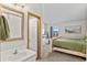 White sink bathroom adjoining bedroom with white bed, with natural lighting from outside the window at 10715 Foxwood Ct, Parker, CO 80138