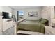 Bedroom featuring a queen-size bed, a large window and a muted color scheme with white distressed furniture at 10715 Foxwood Ct, Parker, CO 80138