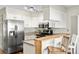 Contemporary kitchen with stainless appliances, granite countertops, and bar seating provides a sleek and functional space at 10715 Foxwood Ct, Parker, CO 80138
