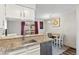 Kitchen features granite counters, stainless steel appliances and a dining area with sliding door access to an outdoor deck at 10715 Foxwood Ct, Parker, CO 80138