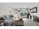 Bright living room showcases a large window, flatscreen television and comfortable seating, perfect for relaxation at 10715 Foxwood Ct, Parker, CO 80138