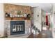 Living room boasts stone fireplace, stairs to the second floor and neutral carpeting for a warm and inviting space at 10715 Foxwood Ct, Parker, CO 80138