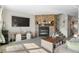 Inviting living room features a stone fireplace, neutral carpeting, and a flatscreen television for cozy evenings at 10715 Foxwood Ct, Parker, CO 80138