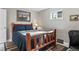Comfortable bedroom with a log frame bed and soft lighting, creating a peaceful and relaxing ambiance at 63 Sillasen Ln, Golden, CO 80403