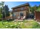 Charming exterior featuring a balcony, patio with chairs, and a beautifully landscaped yard at 63 Sillasen Ln, Golden, CO 80403