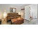 Comfortable living room with futon, side lamps, and wood accent table with stairs at 63 Sillasen Ln, Golden, CO 80403