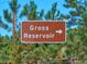 A sign pointing towards Gross Reservoir, surrounded by lush greenery at 63 Sillasen Ln, Golden, CO 80403