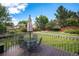 Inviting back deck featuring a table and chairs, perfect for outdoor entertaining and relaxing, with a view of a lush backyard at 16301 E Ida Ave, Centennial, CO 80015