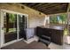 Relaxing back patio featuring a hot tub, perfect for unwinding with easy access to the house through a sliding glass door at 16301 E Ida Ave, Centennial, CO 80015