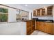 Stylish wet bar with wood cabinets, granite countertop, and open shelving for storage at 16301 E Ida Ave, Centennial, CO 80015