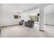 Spacious basement living area featuring plush seating, large windows, and recessed lighting at 16301 E Ida Ave, Centennial, CO 80015
