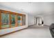 Bright basement living space with large windows providing natural light and scenic backyard views at 16301 E Ida Ave, Centennial, CO 80015