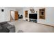 Finished basement featuring a cozy media area, built-in shelves, and a separate office space at 16301 E Ida Ave, Centennial, CO 80015