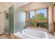 Bright bathroom featuring a soaking tub, large window, and stand up shower at 16301 E Ida Ave, Centennial, CO 80015