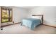 Cozy bedroom with a large window, neutral carpet, and a comfortable-looking bed at 16301 E Ida Ave, Centennial, CO 80015