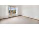 Sunlit bedroom featuring plush carpeting, a large window, and neutral paint at 16301 E Ida Ave, Centennial, CO 80015
