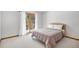 Bright bedroom featuring a cozy bed, neutral decor, and sliding door to an outdoor area at 16301 E Ida Ave, Centennial, CO 80015