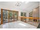 Bright and airy dining area with access to the outdoor deck and adjacent fireplace at 16301 E Ida Ave, Centennial, CO 80015