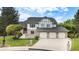 Beautiful two-story home with manicured lawn and a three-car garage at 16301 E Ida Ave, Centennial, CO 80015