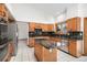 Spacious kitchen featuring granite countertops, stainless steel appliances and white tile floors at 16301 E Ida Ave, Centennial, CO 80015