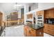 Bright kitchen featuring oak cabinets, granite countertops, and a functional center island at 16301 E Ida Ave, Centennial, CO 80015
