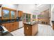 Well-lit kitchen featuring oak cabinets, granite countertops, and views of the living room and fireplace at 16301 E Ida Ave, Centennial, CO 80015