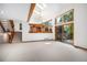 Open-concept living room features large windows, skylights, and access to an outdoor deck at 16301 E Ida Ave, Centennial, CO 80015