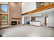 Spacious living room with a brick fireplace, and an open layout to other areas in the home at 16301 E Ida Ave, Centennial, CO 80015