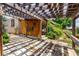 This outdoor patio includes a pergola, wood walls, and stone pavers at 1015 S Fulton Ave, Fort Lupton, CO 80621