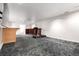 Basement with neutral carpet, open layout, and a treadmill for fitness enthusiasts at 1015 S Fulton Ave, Fort Lupton, CO 80621
