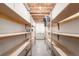 Unfinished basement featuring rows of shelving and an exposed ceiling at 1015 S Fulton Ave, Fort Lupton, CO 80621