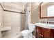 Well-lit bathroom features a tiled walk-in shower and cherry wood vanity at 1015 S Fulton Ave, Fort Lupton, CO 80621