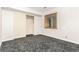 This bedroom features gray carpet, a window with wood trim, and a closet with sliding doors at 1015 S Fulton Ave, Fort Lupton, CO 80621
