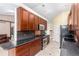 Well-equipped kitchen with dark granite countertops, stainless steel appliances, and modern cabinetry at 1015 S Fulton Ave, Fort Lupton, CO 80621