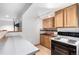 Basement kitchen features bar seating and full-sized appliances at 1015 S Fulton Ave, Fort Lupton, CO 80621