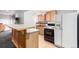 Basement kitchen features bar seating and full-sized appliances at 1015 S Fulton Ave, Fort Lupton, CO 80621