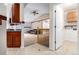 Open-concept living room boasts vaulted ceilings and seamless transition to dining area at 1015 S Fulton Ave, Fort Lupton, CO 80621