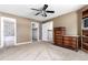 Bedroom featuring an ensuite bathroom, walk-in closet and ceiling fan at 1015 S Fulton Ave, Fort Lupton, CO 80621