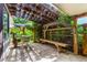This shaded patio features a pergola, bench, grill, and a small table at 1015 S Fulton Ave, Fort Lupton, CO 80621