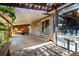 This covered patio includes a bench, brick walls, and a sliding glass door at 1015 S Fulton Ave, Fort Lupton, CO 80621