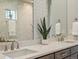 Elegant bathroom featuring double sinks, quartz countertops, and modern fixtures at 2113 Fountain Cir, Erie, CO 80516