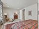 Spacious bedroom featuring a plaid comforter, ample lighting, and comfortable seating at 2113 Fountain Cir, Erie, CO 80516