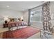 Bright bedroom with a plaid comforter, decorative rug, and large window at 2113 Fountain Cir, Erie, CO 80516