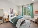 Comfortable bedroom featuring a large window and green curtains, soft rug, and cozy furnishings at 2113 Fountain Cir, Erie, CO 80516