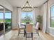 Bright dining area features a modern chandelier, large window with view, and stylish seating for four at 2113 Fountain Cir, Erie, CO 80516