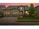 Charming home with a two-car garage, complemented by lush landscaping and a warm, inviting exterior at 2113 Fountain Cir, Erie, CO 80516
